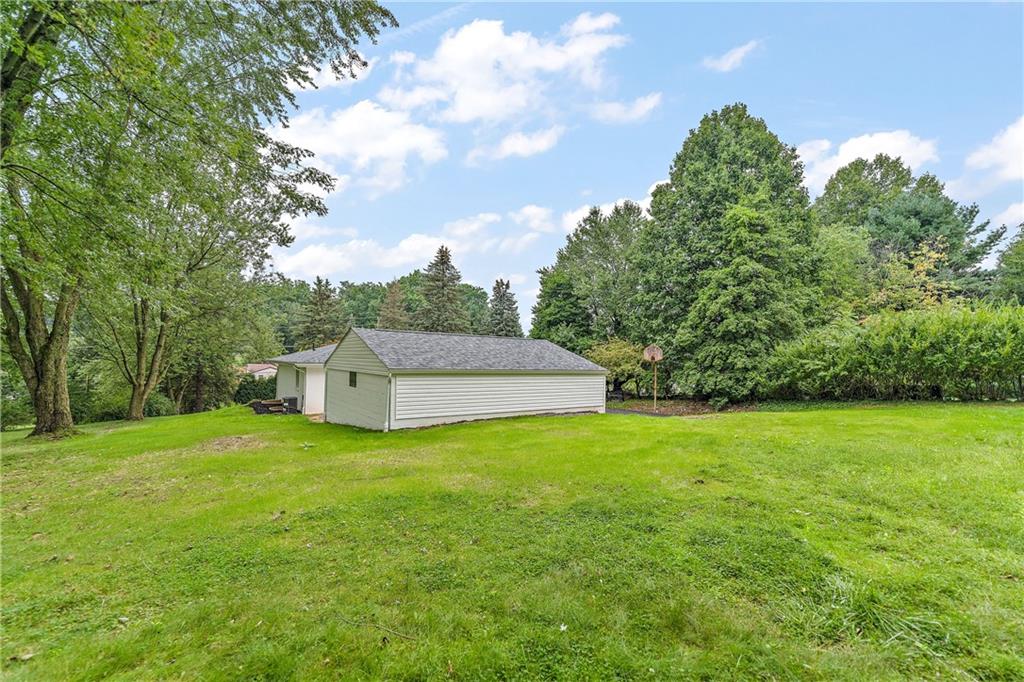 414 Thompson Run Road Pittsburgh, PA 15237 - Photo 22 of 25 a white house with a big yard and large trees
