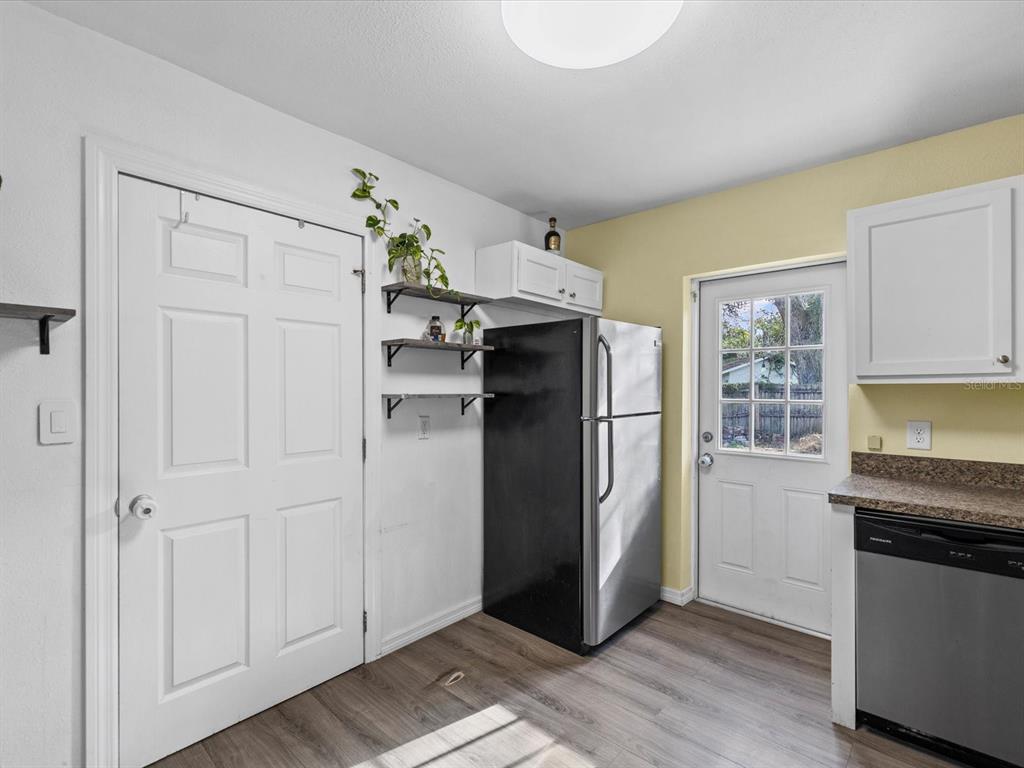 7114 Carlow Street New Port Richey, FL 34653 - Photo 14 of 65 a kitchen with stainless steel appliances granite countertop a refrigerator and a stove top oven
