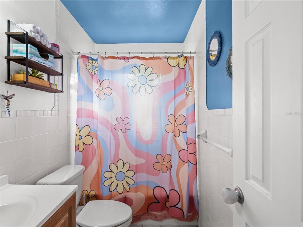 7114 Carlow Street New Port Richey, FL 34653 - Photo 21 of 65 a bathroom with a sink toilet and shower curtain