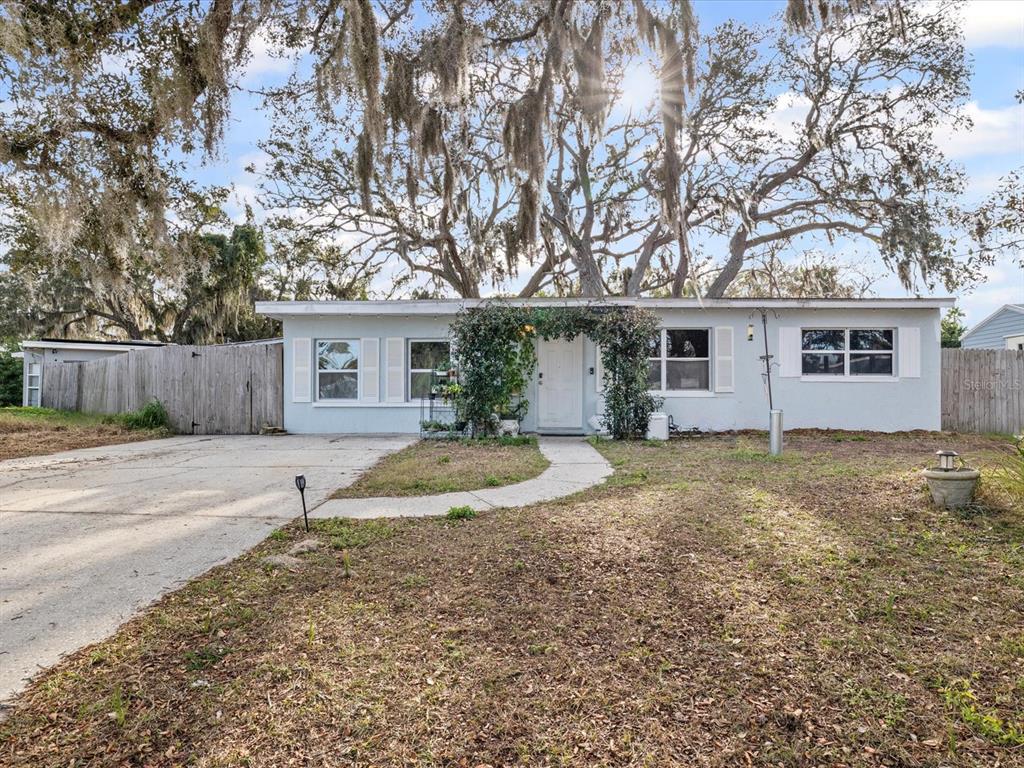 7114 Carlow Street New Port Richey, FL 34653 - Photo 4 of 65 a view of a house with a yard and large tree
