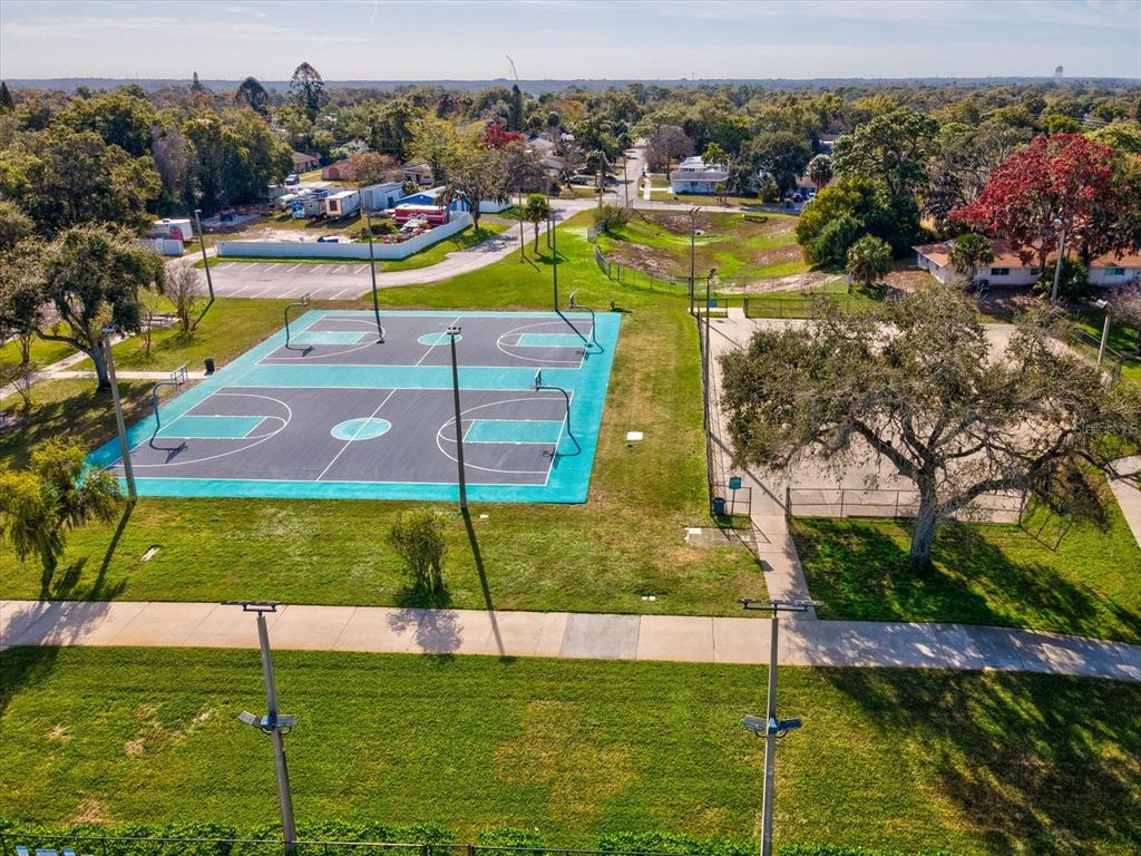 7114 Carlow Street New Port Richey, FL 34653 - Photo 51 of 65 a view of a swimming pool with a lawn chairs