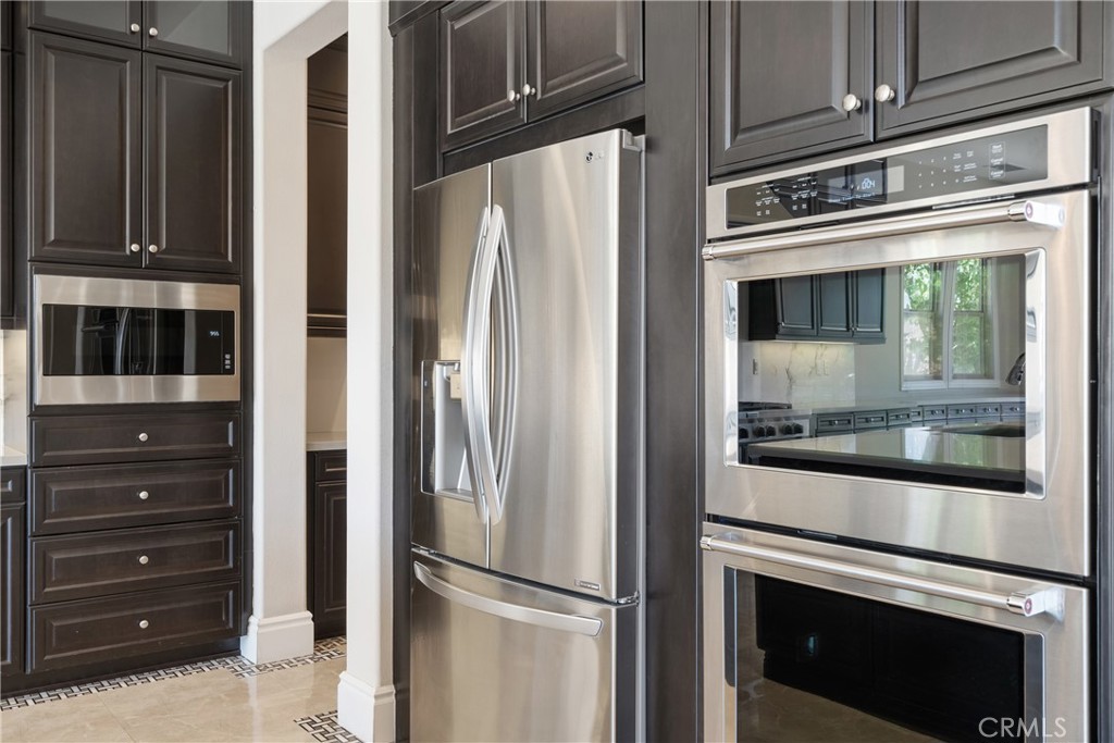 2498 Santa Paula Drive Brea, CA 92821 - Photo 24 of 75 a metallic refrigerator freezer sitting in a kitchen