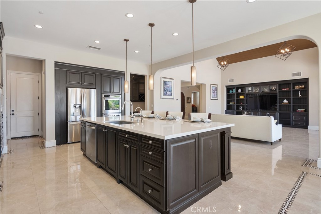 2498 Santa Paula Drive Brea, CA 92821 - Photo 26 of 75 a large kitchen with a large counter top a sink stainless steel appliances and cabinets