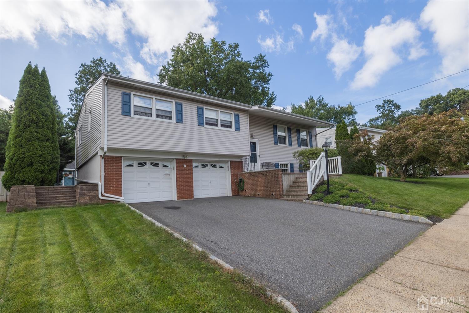 8 Wilk Road Edison, NJ 08837 - Photo 2 of 20 a front view of a house with a yard and garage