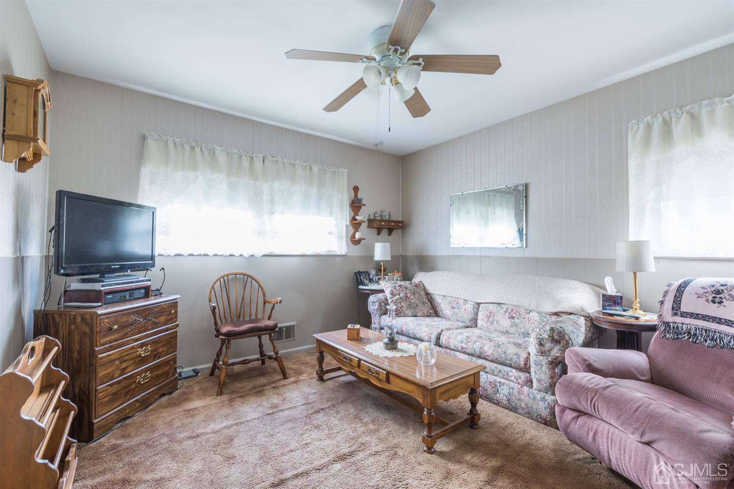 8 Wilk Road Edison, NJ 08837 - Photo 12 of 20 a living room with furniture and a flat screen tv