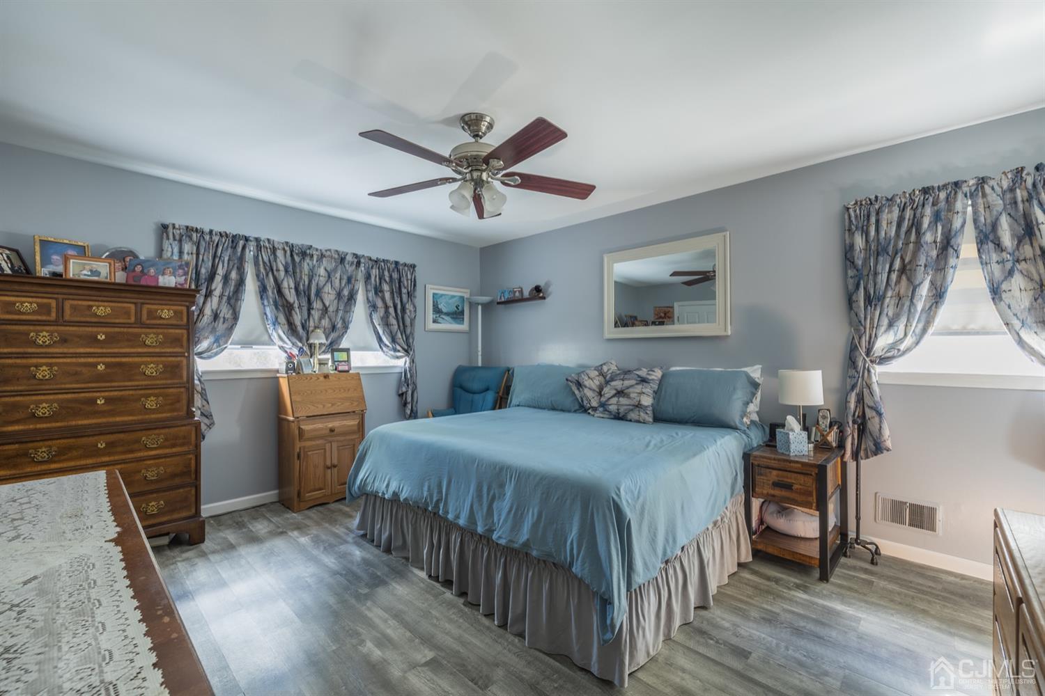 8 Wilk Road Edison, NJ 08837 - Photo 13 of 20 a bedroom with a bed and a chandelier