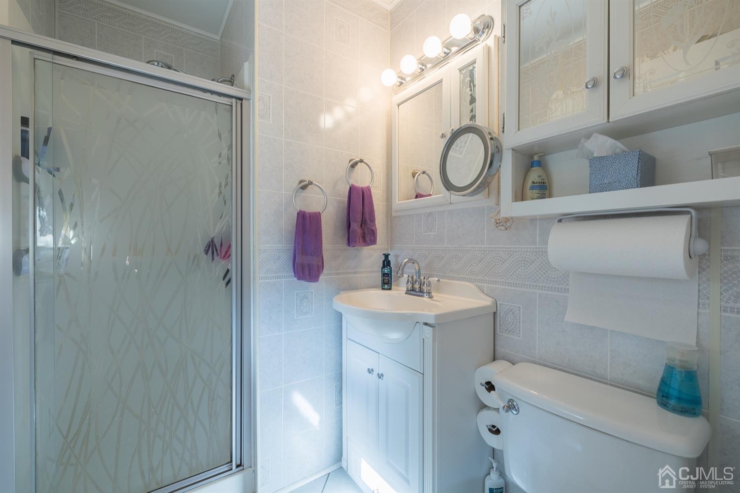 8 Wilk Road Edison, NJ 08837 - Photo 14 of 20 a bathroom with a sink vanity mirror and toilet
