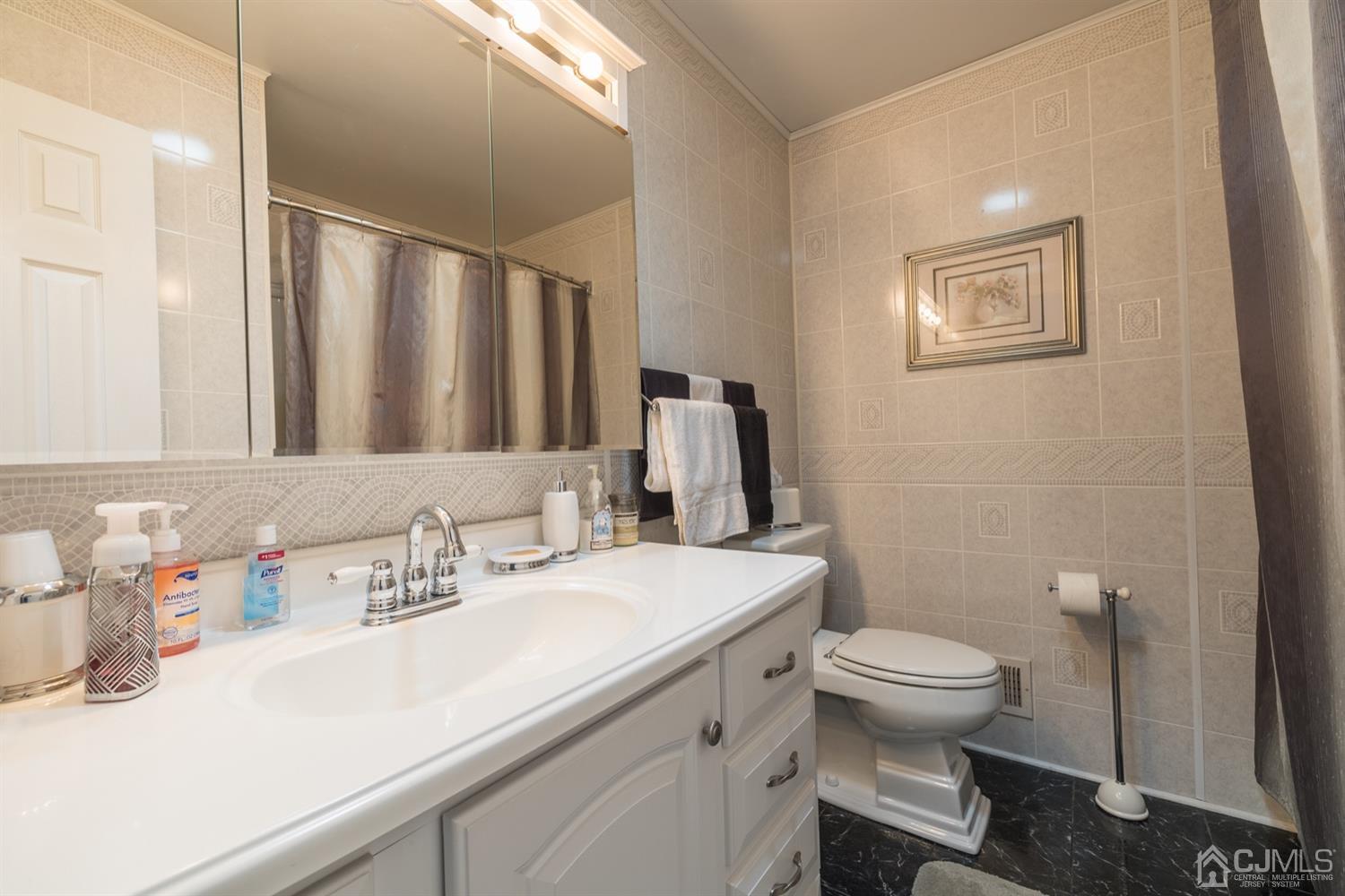 8 Wilk Road Edison, NJ 08837 - Photo 15 of 20 a bathroom with a sink toilet and mirror
