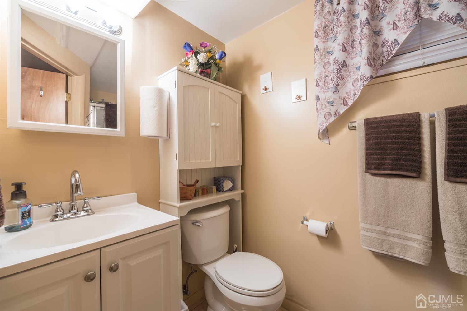 8 Wilk Road Edison, NJ 08837 - Photo 16 of 20 a bathroom with a sink mirror vanity and toilet