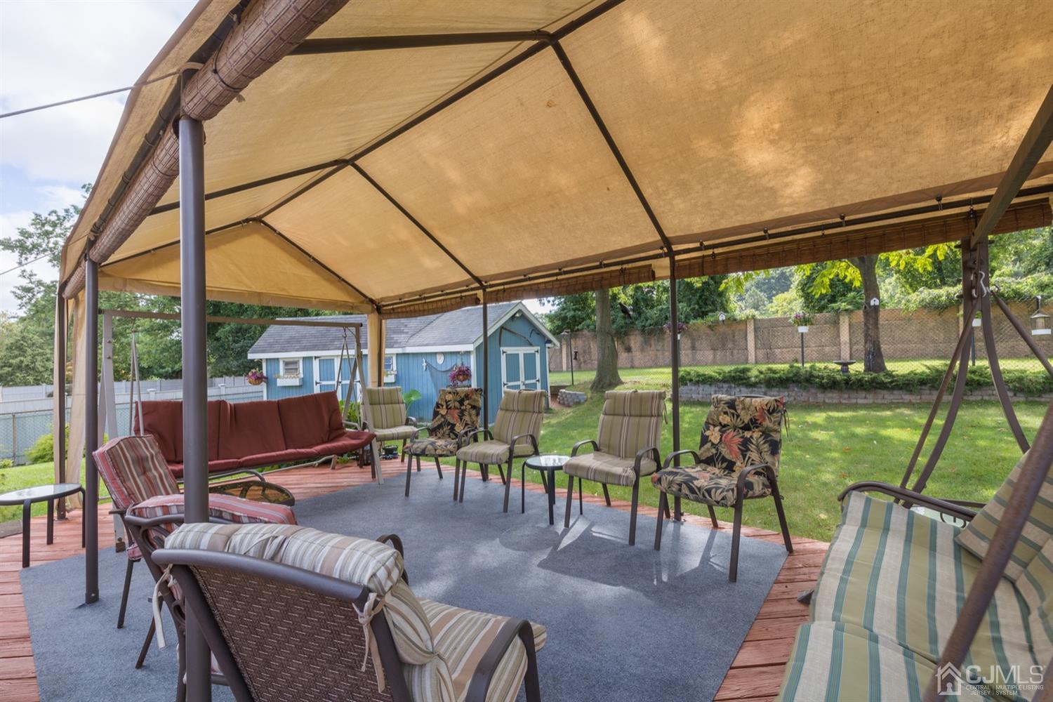 8 Wilk Road Edison, NJ 08837 - Photo 18 of 20 a view of a patio with a table chairs and a backyard