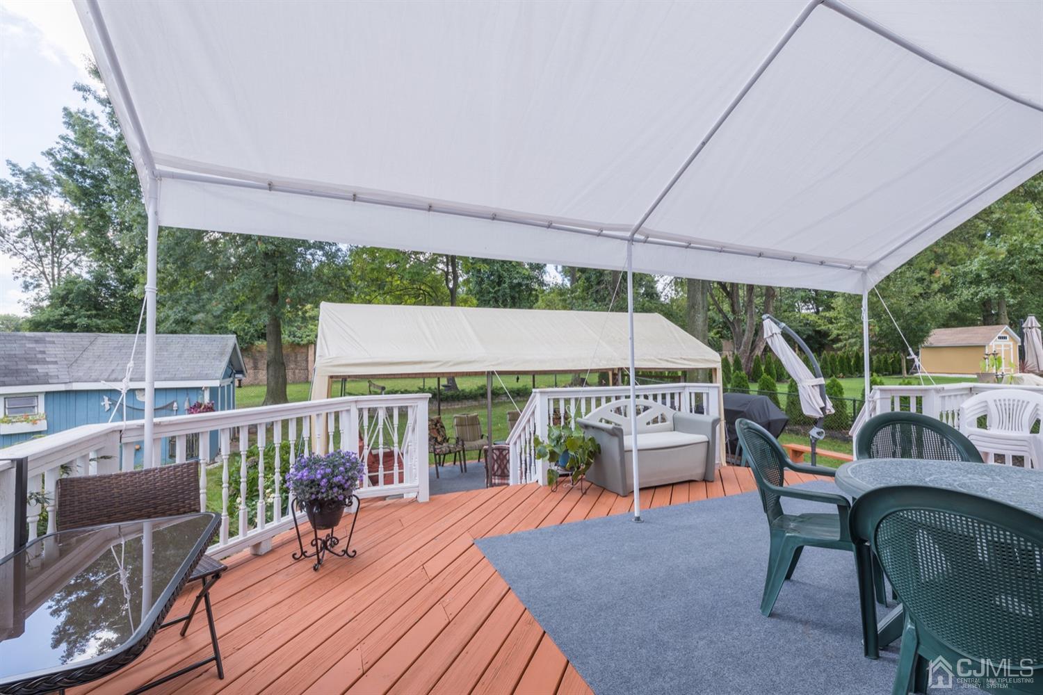 8 Wilk Road Edison, NJ 08837 - Photo 19 of 20 a view of a patio with a dining table and chairs with wooden floor
