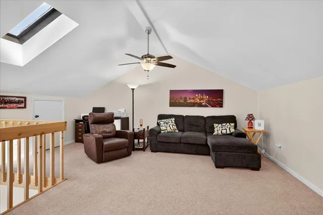 a living room with furniture and a ceiling fan