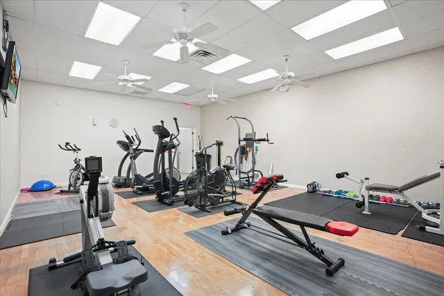 a room with gym equipment and a flat screen tv