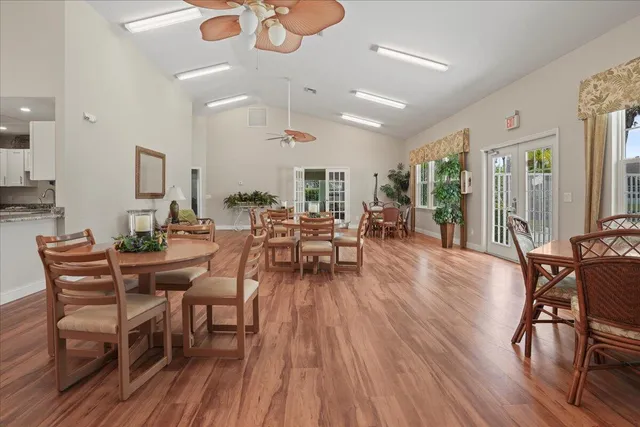 a living room with furniture a wooden floor and a chandelier