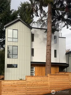 a view of a house with a large tree