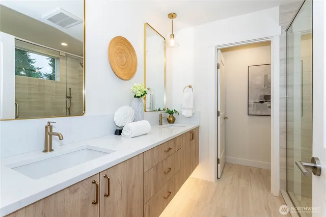 a bathroom with a double vanity sink and a mirror
