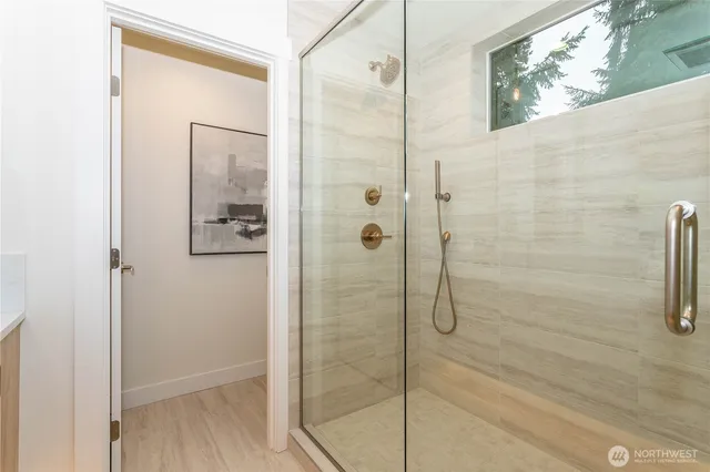 a bathroom with a glass shower door