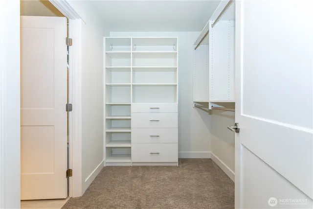 a view of walk in closet with empty racks