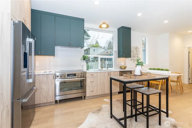 a kitchen with a stove a refrigerator and a table