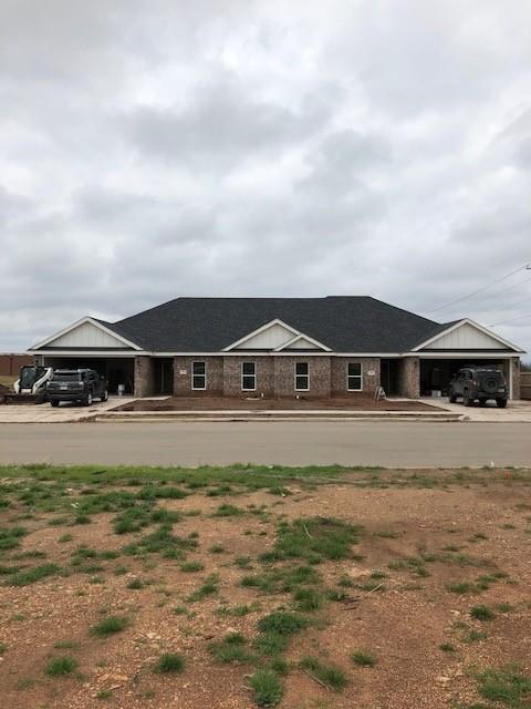Single story home with driveway and an attached garage