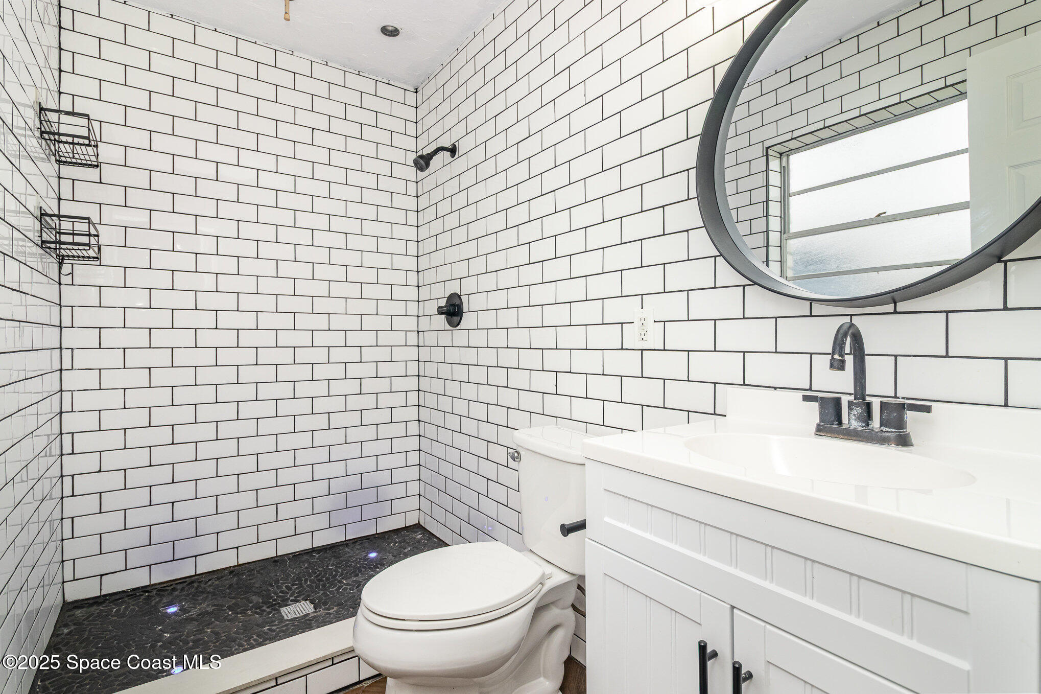 13 Scott Lane Rockledge, FL 32955 - Photo 13 of 26 a bathroom with a sink a toilet and a mirror