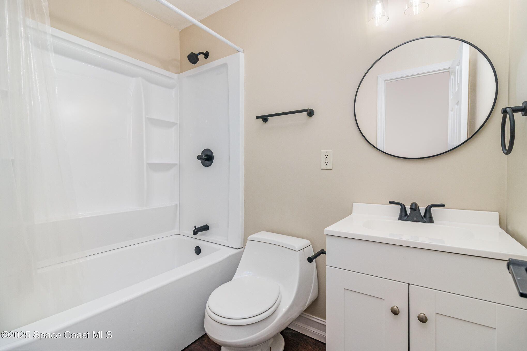 13 Scott Lane Rockledge, FL 32955 - Photo 18 of 26 a bathroom with a toilet sink vanity tub and mirror
