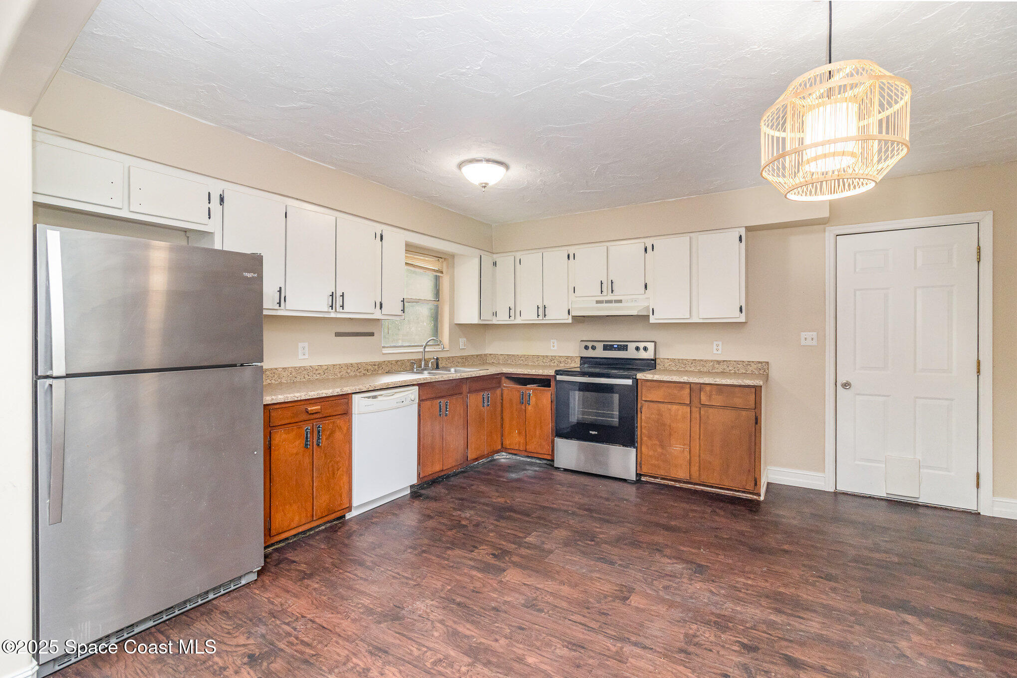 13 Scott Lane Rockledge, FL 32955 - Photo 6 of 26 a kitchen with granite countertop stainless steel appliances a refrigerator a stove a sink cabinets and a dining table