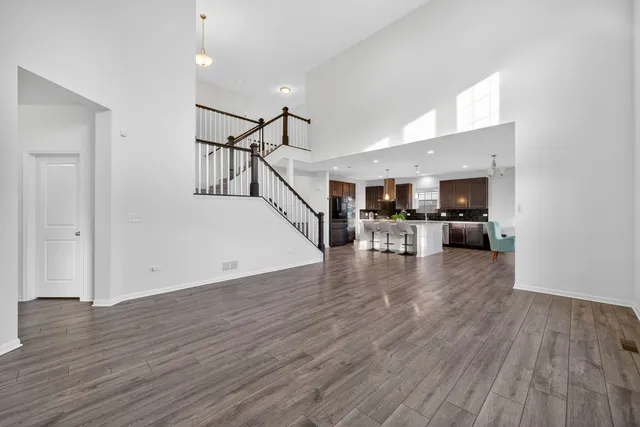 a view of a livingroom with wooden floor and stairs