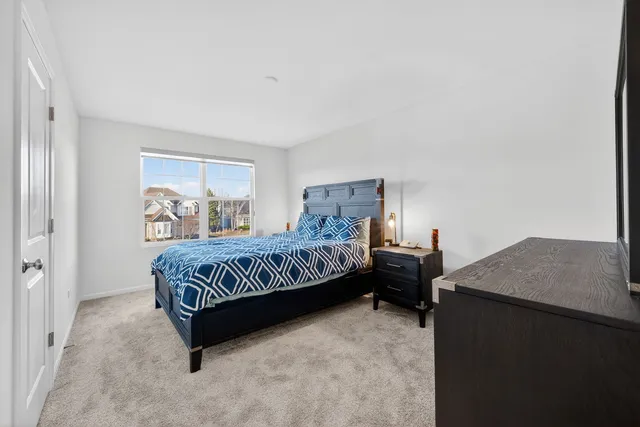 a bedroom with a bed and a table in it