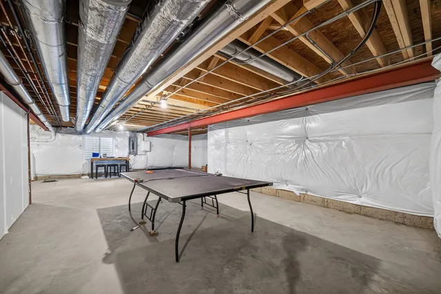 a roof deck with table and chairs