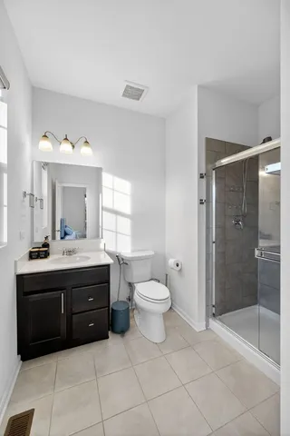 a spacious bathroom with a sink toilet and shower