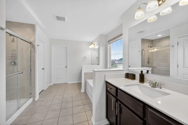 a bathroom with a sink double vanity and a mirror