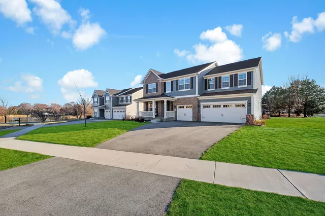 a front view of house with yard and green space