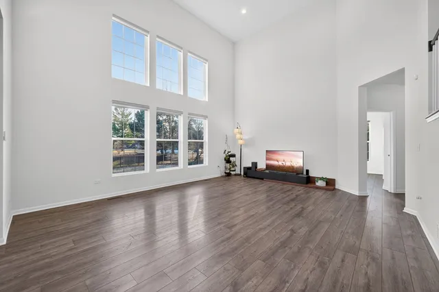 a view of a livingroom with wooden floor and furniture