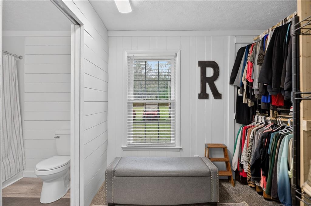 3590 Roosterville Road Roopville, GA 30170 - Photo 37 of 66 a view of walk in closet with clothes and shoes