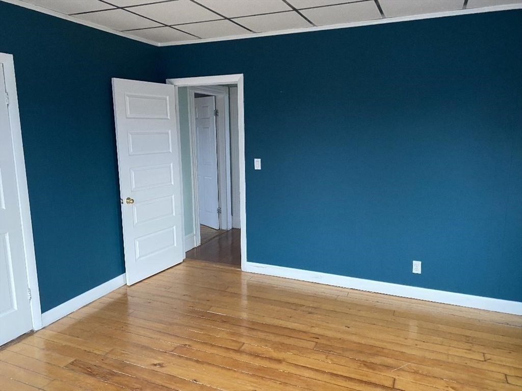 147 Stetson Street, Unit 2 Fall River, MA 02720 - Photo 6 of 8 a view of an empty room with wooden floor