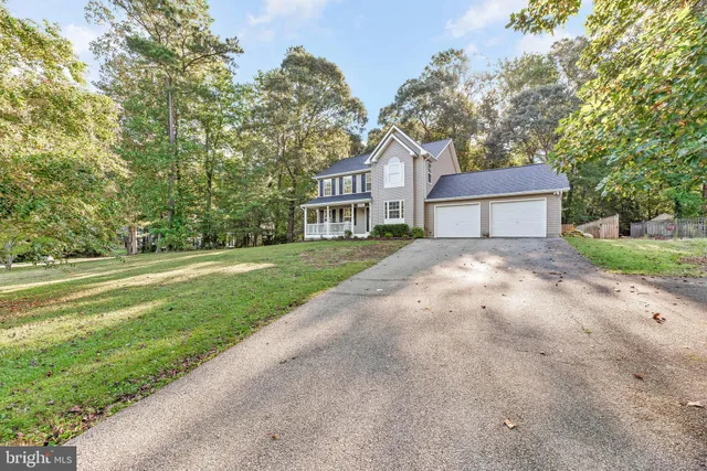 a view of house with yard and green space