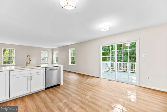 a large white kitchen with a sink and dish washer