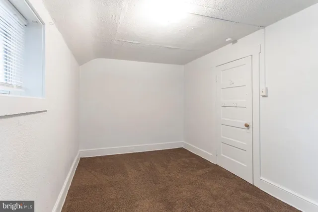 an empty room with a empty space and windows