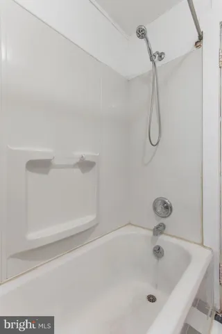 a bathroom with a bath tub with a shower