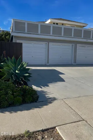 a front view of a house with plants