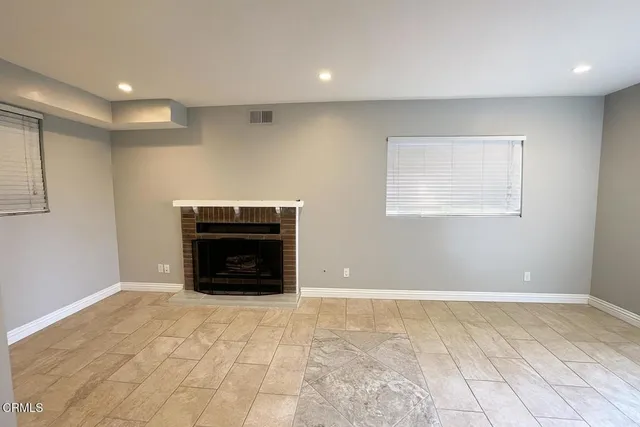a view of empty room with a fireplace