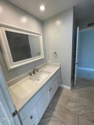 a bathroom with a sink double vanity and a mirror