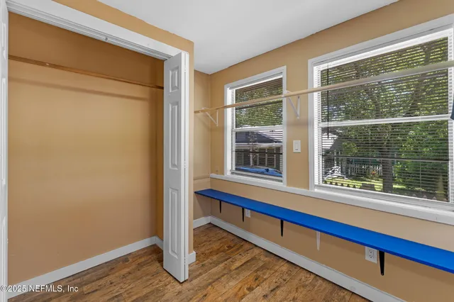 a wooden bench sitting in front of a window