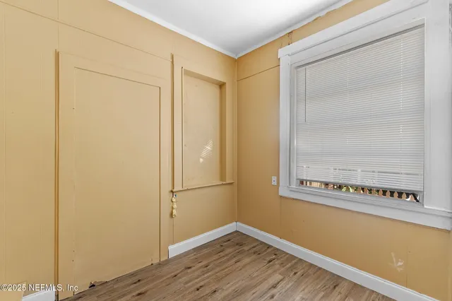 a view of a small space with wooden floor