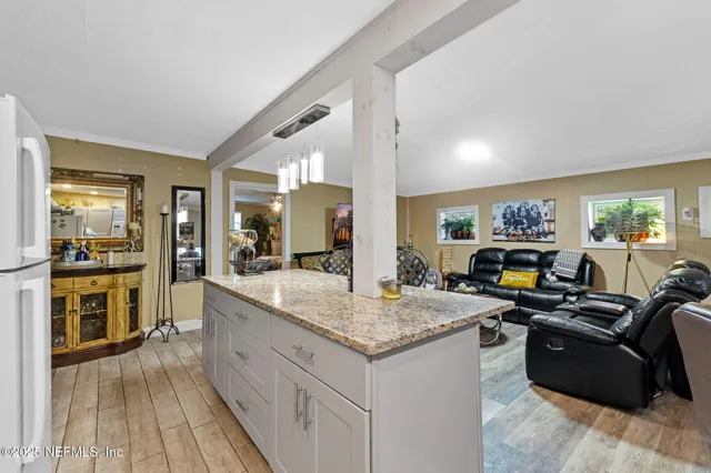 a large kitchen with granite countertop a lot of counter top space
