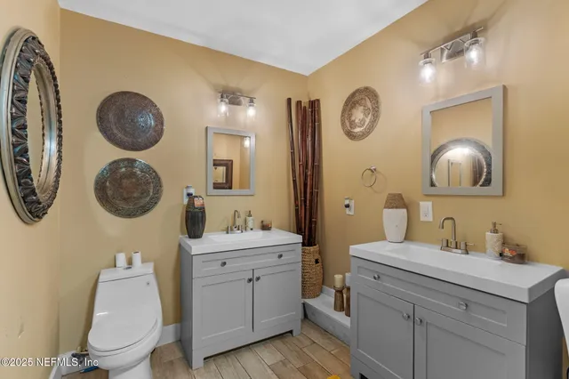 a bathroom with a toilet a sink and a mirror