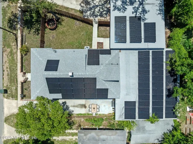 an aerial view of a house with a yard basket ball court and outdoor seating