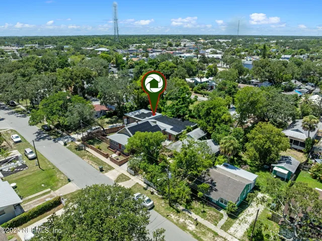 an aerial view of a house with yard swimming pool and outdoor seating