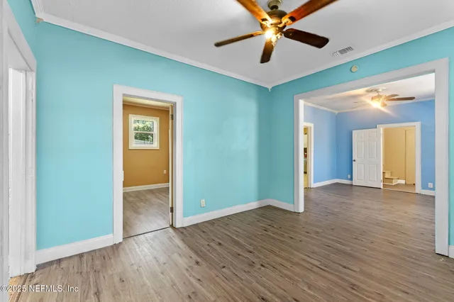 wooden floor in an empty room with a window
